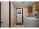 Laundry room with washer, dryer, storage cabinets and door to backyard at 13137 Kansas Ave, Astatula, FL 34705