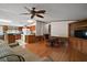 Comfortable living room with hardwood floors, a rocking chair, and kitchen access at 13137 Kansas Ave, Astatula, FL 34705