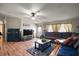 Open-concept living room featuring wood floors, a large television, and comfortable seating at 13137 Kansas Ave, Astatula, FL 34705