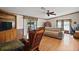 Cozy living room with wood floors, built-in shelving, and sliding glass doors to the exterior at 13137 Kansas Ave, Astatula, FL 34705