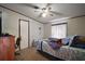 Bright main bedroom with ceiling fan, a window, and carpet flooring at 13137 Kansas Ave, Astatula, FL 34705