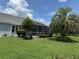 Lush backyard with beautiful landscaping and a screened-in patio area, perfect for outdoor living at 1512 Nueva Pl, The Villages, FL 32159