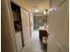 Bathroom featuring tile floors, vanity, shower, and a closet with laundry, combining style and functionality at 1512 Nueva Pl, The Villages, FL 32159