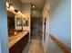 Spacious bathroom with a double vanity, walk-in shower with glass door and tile surround at 1512 Nueva Pl, The Villages, FL 32159