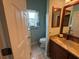 Compact bathroom featuring a vanity, sink, toilet and a window for natural light at 1512 Nueva Pl, The Villages, FL 32159