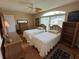 Bright bedroom features two twin beds, a ceiling fan, and wicker furniture at 1512 Nueva Pl, The Villages, FL 32159