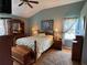 The bedroom offers a calming sanctuary with soft colors, wood floors and natural light at 1512 Nueva Pl, The Villages, FL 32159