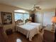 Bright bedroom features two twin beds, a ceiling fan, and wicker furniture at 1512 Nueva Pl, The Villages, FL 32159