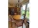 Cozy dining area featuring a round table, wooden chairs and lots of natural light at 1512 Nueva Pl, The Villages, FL 32159