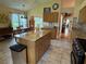 Bright kitchen featuring an island, tile flooring, and ample cabinet space at 1512 Nueva Pl, The Villages, FL 32159