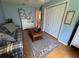 Comfortable living room with blue walls, a large rug, and a view to other rooms at 1512 Nueva Pl, The Villages, FL 32159
