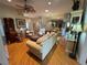 Spacious living room featuring hardwood floors, stylish furnishings, and elegant decor at 1512 Nueva Pl, The Villages, FL 32159
