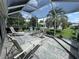 Inviting screened patio offers comfortable seating and tranquil views of the landscaped yard at 1512 Nueva Pl, The Villages, FL 32159