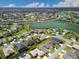Expansive aerial view of a residential community with a picturesque lake at 17108 Se 111Th Terrace Rd, Summerfield, FL 34491