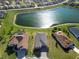 An aerial view of the community featuring homes surrounding a large pond at 17108 Se 111Th Terrace Rd, Summerfield, FL 34491