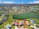 Expansive aerial view of the property in community, showcasing the nearby lake at 17108 Se 111Th Terrace Rd, Summerfield, FL 34491