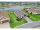 This single-story home features a paver driveway, mature landscaping, and a serene view of the lake at 17108 Se 111Th Terrace Rd, Summerfield, FL 34491