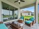 Back porch with chairs and table set overlooking the lake at 17108 Se 111Th Terrace Rd, Summerfield, FL 34491
