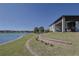 Beautiful lakeside backyard featuring a covered patio and well-maintained lawn at 17108 Se 111Th Terrace Rd, Summerfield, FL 34491