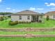 Aerial view of the backyard featuring a covered patio and terraced retaining wall at 17108 Se 111Th Terrace Rd, Summerfield, FL 34491