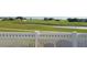 Serene backyard view overlooking a lush green space, pond, and golf course beyond a white decorative fence at 17108 Se 111Th Terrace Rd, Summerfield, FL 34491