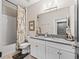 Bathroom featuring vanity with granite countertops and shower with patterned curtain at 17108 Se 111Th Terrace Rd, Summerfield, FL 34491