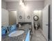 Bathroom featuring granite countertops, double sinks, and a separate toilet room for added privacy at 17108 Se 111Th Terrace Rd, Summerfield, FL 34491