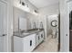 Bright bathroom featuring a double vanity with granite countertops and modern fixtures at 17108 Se 111Th Terrace Rd, Summerfield, FL 34491