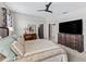Comfortable carpeted bedroom with a ceiling fan, dresser, and a closet with built in shelving at 17108 Se 111Th Terrace Rd, Summerfield, FL 34491