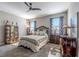 Bedroom with neutral walls, ceiling fan, large windows, and carpet flooring at 17108 Se 111Th Terrace Rd, Summerfield, FL 34491