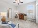 Cozy bedroom featuring a ceiling fan and a window with blinds at 17108 Se 111Th Terrace Rd, Summerfield, FL 34491