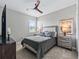 Stylish bedroom featuring a modern ceiling fan and window with blinds at 17108 Se 111Th Terrace Rd, Summerfield, FL 34491