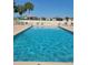 Inviting community pool with clear blue water, surrounded by lounge chairs and a serene atmosphere at 17108 Se 111Th Terrace Rd, Summerfield, FL 34491