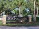 Stonecrest community sign with stone pillars, manicured landscaping and palm trees at 17108 Se 111Th Terrace Rd, Summerfield, FL 34491
