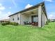 Exterior view of home with patio overlooking beautifully landscaped backyard at 17108 Se 111Th Terrace Rd, Summerfield, FL 34491