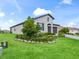 Single-story home with a two-car garage showcasing a well-maintained lawn and landscaping at 17108 Se 111Th Terrace Rd, Summerfield, FL 34491