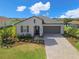 Charming single-story home featuring a well-manicured front yard and driveway at 17108 Se 111Th Terrace Rd, Summerfield, FL 34491