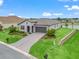 Charming single-story home featuring an arched entryway, paver driveway and lush landscaping at 17108 Se 111Th Terrace Rd, Summerfield, FL 34491