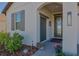 Inviting front entrance with a decorative glass front door and manicured landscaping at 17108 Se 111Th Terrace Rd, Summerfield, FL 34491