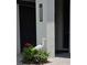 Inviting front entrance with an elegant house number sign and vibrant flowerbed detail at 17108 Se 111Th Terrace Rd, Summerfield, FL 34491