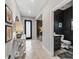 Hallway with tile flooring and entry to a bathroom, leading to other living spaces at 17108 Se 111Th Terrace Rd, Summerfield, FL 34491