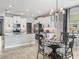Elegant kitchen and dining area with granite counters, stainless steel appliances, and decorative lighting fixtures create a stylish space at 17108 Se 111Th Terrace Rd, Summerfield, FL 34491