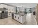 Bright kitchen features a large island, stainless steel appliances, and an open layout to the living area at 17108 Se 111Th Terrace Rd, Summerfield, FL 34491