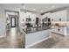 Open concept kitchen with large island, stainless appliances, and white cabinets flows to the rest of the home at 17108 Se 111Th Terrace Rd, Summerfield, FL 34491