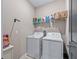 Efficient laundry room with washer, dryer, and shelving for storage and organization at 17108 Se 111Th Terrace Rd, Summerfield, FL 34491