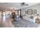 Living room featuring tile floors, neutral decor, and an open view to the kitchen at 17108 Se 111Th Terrace Rd, Summerfield, FL 34491
