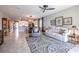 Spacious living room featuring tile floors, neutral decor, and an open view to the kitchen at 17108 Se 111Th Terrace Rd, Summerfield, FL 34491