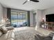 Bright living room with a ceiling fan, tile flooring, and sliding glass doors to a patio with lake views at 17108 Se 111Th Terrace Rd, Summerfield, FL 34491