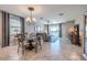Open-concept living and dining area with tile floors and slider to the pool at 17108 Se 111Th Terrace Rd, Summerfield, FL 34491