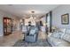 Open-concept living room featuring tile floors, neutral decor, and an open view to the kitchen at 17108 Se 111Th Terrace Rd, Summerfield, FL 34491